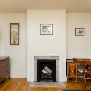 Day use room with TV, workspace, and chimney at The Farrington Inn.