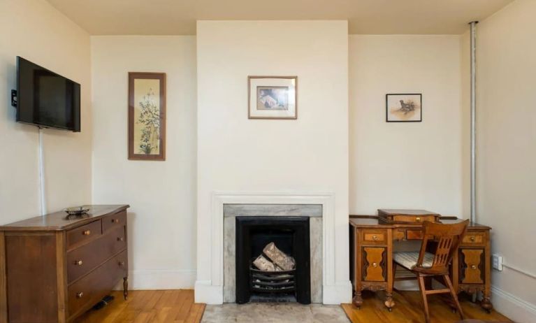 Day use room with TV, workspace, and chimney at The Farrington Inn.