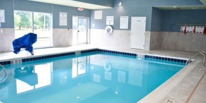 Indoor pool with chairs at Holiday Inn Express & Suites Bensenville - O'Hare.