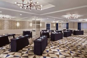 Large meeting room in Royal Sonesta Washington DC Dupont Circle, with tables of three seats each arranged in a classroom style.