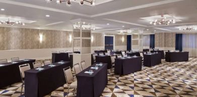 Large meeting room in Royal Sonesta Washington DC Dupont Circle, with tables of three seats each arranged in a classroom style.