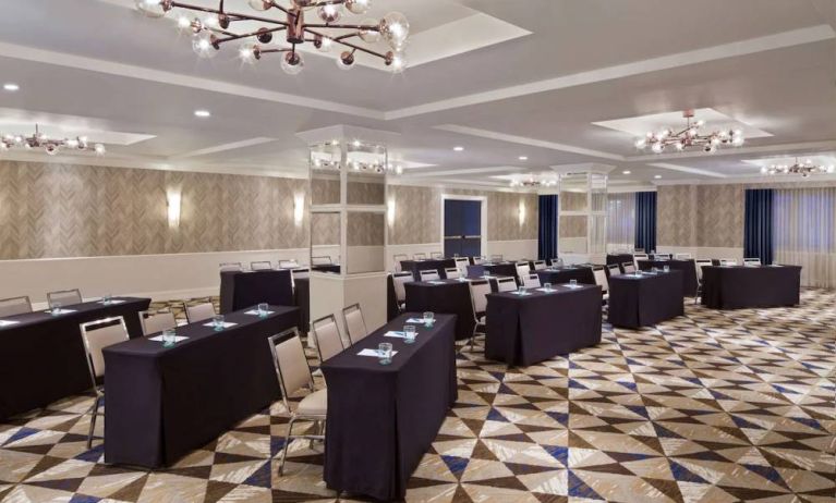 Large meeting room in Royal Sonesta Washington DC Dupont Circle, with tables of three seats each arranged in a classroom style.