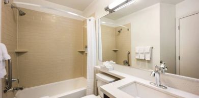 Sonesta Simply Suites Nashville Brentwood guest bathroom, including shower and bath, sink and lavatory.