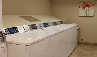 The hotel’s laundry room has numerous machines for guests to use, and art on the wall.