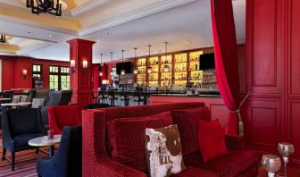 The Stephen F Austin Royal Sonesta Hotel’s bar has vibrant red decor, and a mix of comfortable table seating and traditional bar stools.