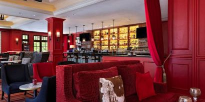 The Stephen F Austin Royal Sonesta Hotel’s bar has vibrant red decor, and a mix of comfortable table seating and traditional bar stools.