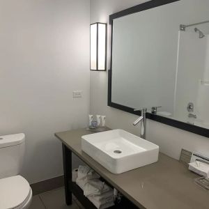 Guest bathroom with shower at Country Inn & Suites By Radisson, Chicago O'Hare South.