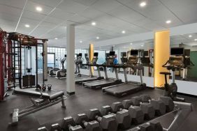 The hotel fitness center has rows of free weights, both dumbbells and kettlebells, and an assortment of exercise machines.