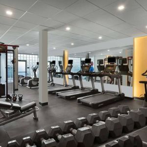 The hotel fitness center has rows of free weights, both dumbbells and kettlebells, and an assortment of exercise machines.