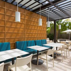 The hotel patio features tables and chairs where guests can relax and socialize in the open air.