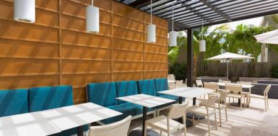 The hotel patio features tables and chairs where guests can relax and socialize in the open air.