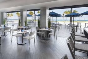 Sonesta Fort Lauderdale Beach’s Steelpan Restaurant serves up Caribbean-American fusion fare, with small tables, a hard floor and ocean views.