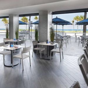 Sonesta Fort Lauderdale Beach’s Steelpan Restaurant serves up Caribbean-American fusion fare, with small tables, a hard floor and ocean views.