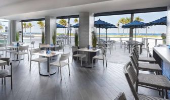 Sonesta Fort Lauderdale Beach’s Steelpan Restaurant serves up Caribbean-American fusion fare, with small tables, a hard floor and ocean views.