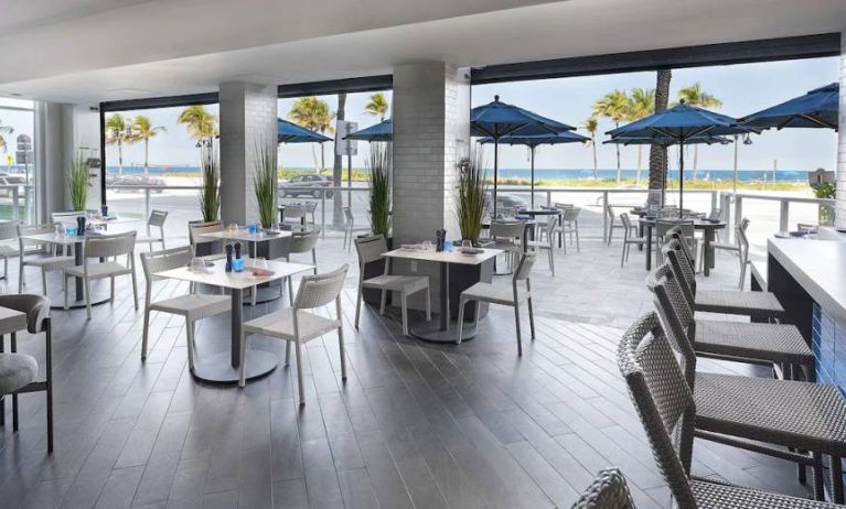 Sonesta Fort Lauderdale Beach’s Steelpan Restaurant serves up Caribbean-American fusion fare, with small tables, a hard floor and ocean views.