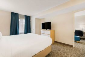 Double bed guest room in Sonesta ES Suites Charlotte Arrowood, including window and television.