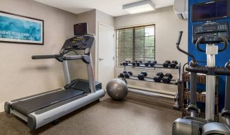 Sonesta ES Suites Charlotte Arrowood’s fitness center is equipped with rows of free weights and various exercise machines.