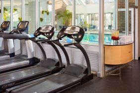 The hotel fitness center has numerous exercise machines and is adjacent to the indoor pool.