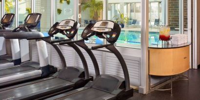 The hotel fitness center has numerous exercise machines and is adjacent to the indoor pool.