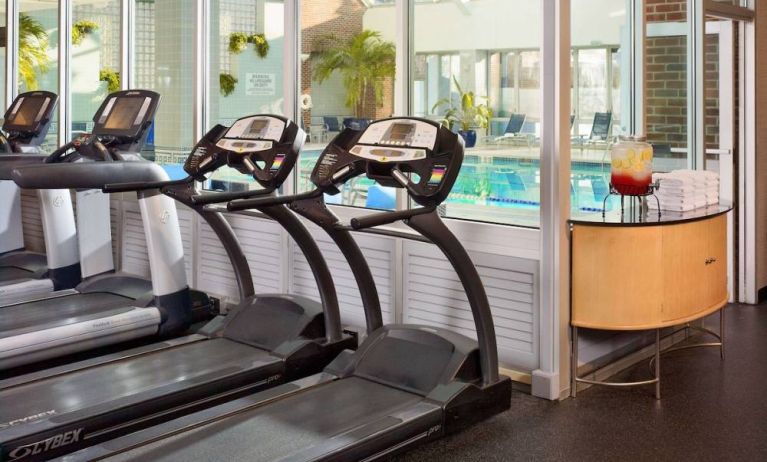 The hotel fitness center has numerous exercise machines and is adjacent to the indoor pool.