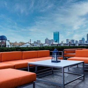 Royal Sonesta Boston’s patio provides comfortable outdoor seating and large coffee tables.