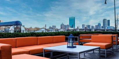 Royal Sonesta Boston’s patio provides comfortable outdoor seating and large coffee tables.