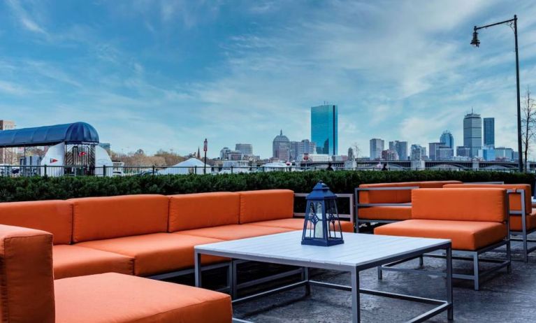 Royal Sonesta Boston’s patio provides comfortable outdoor seating and large coffee tables.