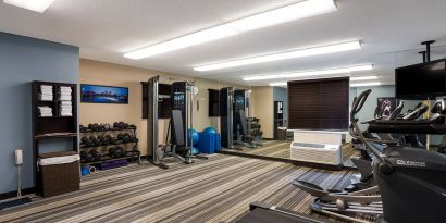 Sonesta Simply Suites Des Moines’ fitness center is equipped with rows of free weights, plus an assortment of exercise machines, and a TV.