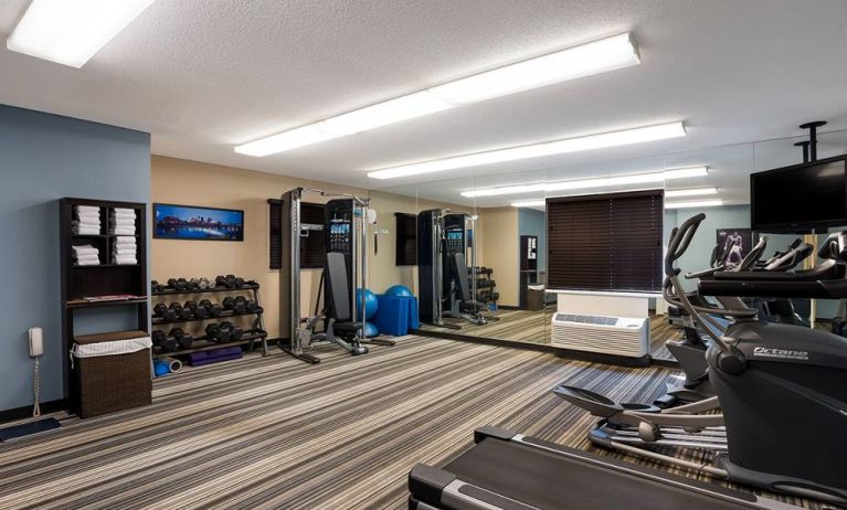 Sonesta Simply Suites Des Moines’ fitness center is equipped with rows of free weights, plus an assortment of exercise machines, and a TV.