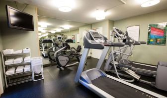 The fitness center at Sonesta ES Suites Austin The Domain Area includes a widescreen television, plenty of towels, and multiple exercise machines.