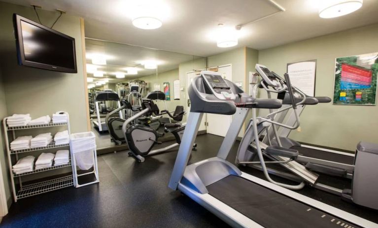 The fitness center at Sonesta ES Suites Austin The Domain Area includes a widescreen television, plenty of towels, and multiple exercise machines.