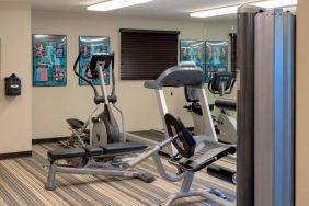 Sonesta Simply Suites Pittsburgh Airport’s fitness center is equipped with an assortment of exercise machines and a bench for those using weights.