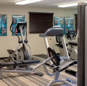 Sonesta Simply Suites Pittsburgh Airport’s fitness center is equipped with an assortment of exercise machines and a bench for those using weights.