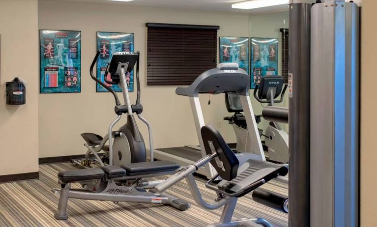 Sonesta Simply Suites Pittsburgh Airport’s fitness center is equipped with an assortment of exercise machines and a bench for those using weights.