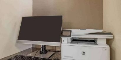 The hotel business center includes monitor, keyboard, and mouse, plus a printer.