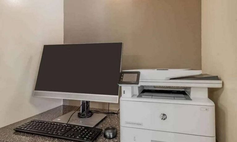 The hotel business center includes monitor, keyboard, and mouse, plus a printer.