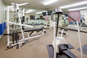 Sonesta Simply Suites Salt Lake City Airport’s fitness center has a diverse array of exercise machines and a television set.