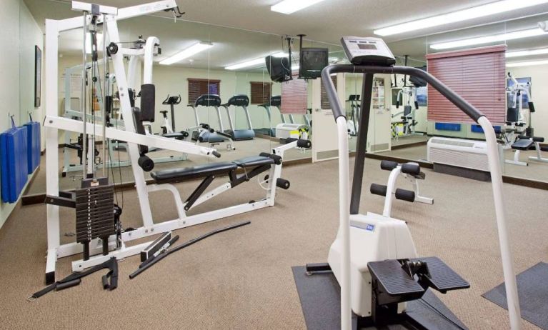 Sonesta Simply Suites Salt Lake City Airport’s fitness center has a diverse array of exercise machines and a television set.