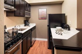 Sonesta Simply Suites Seattle Renton guest room kitchen, furnished with oven, hob, microwave, and fridge-freezer.