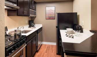 Sonesta Simply Suites Seattle Renton guest room kitchen, furnished with oven, hob, microwave, and fridge-freezer.