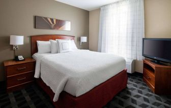 Double bed guest room in Sonesta Simply Suites Seattle Renton, featuring a large window and widescreen television.