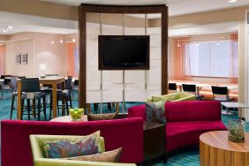 Sonesta Select Seattle Renton’s lobby lounge has comfortable seating, coffee tables, and a wall-mounted TV.