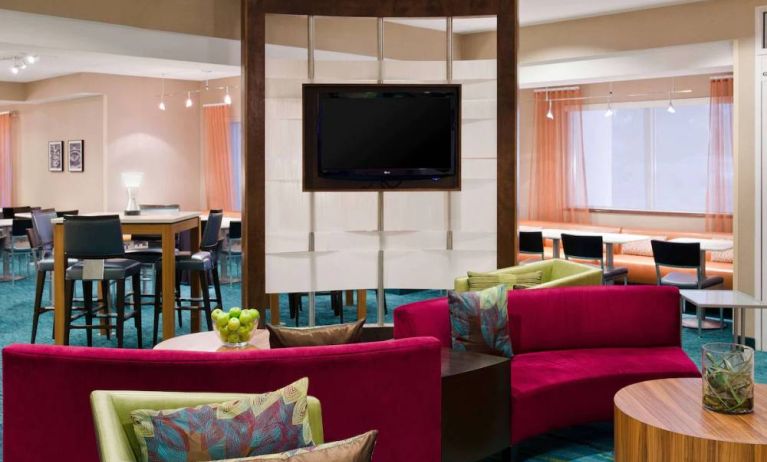 Sonesta Select Seattle Renton’s lobby lounge has comfortable seating, coffee tables, and a wall-mounted TV.