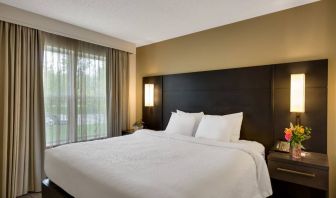 Double bed guest room in Sonesta ES Suites Parsippany Morris Plains, with bedside lighting and a large window.