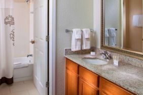 Sonesta ES Suites Birmingham Homewood guest bathroom, with sink, mirror, and bath (including shower).