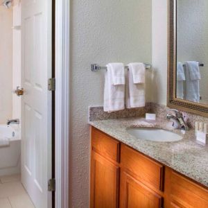 Sonesta ES Suites Birmingham Homewood guest bathroom, with sink, mirror, and bath (including shower).