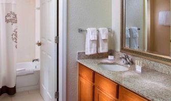 Sonesta ES Suites Birmingham Homewood guest bathroom, with sink, mirror, and bath (including shower).