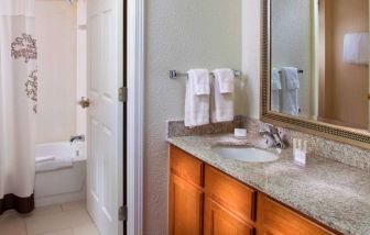 Sonesta ES Suites Birmingham Homewood guest bathroom, with sink, mirror, and bath (including shower).