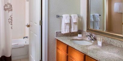 Sonesta ES Suites Birmingham Homewood guest bathroom, with sink, mirror, and bath (including shower).