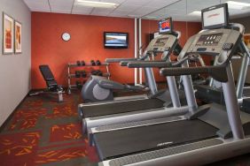 Sonesta ES Suites Birmingham Homewood’s fitness center features treadmills, an elliptical, bench, and rows of free weights, plus a TV.